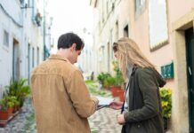How to Get Your Ex Back Fast Without Him Knowing (5 Powerful Ancient Methods) Two travelers exploring a charming European street, using a map for navigation. - how to get my ex back fast without him knowing