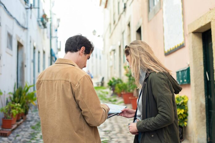 Two travelers exploring a charming European street, using a map for navigation. - how to get my ex back fast without him knowing