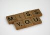 How to Make Your Ex Miss You Desperately Using Ancient African Love Spells (24-Hour Results) Close-up of Scrabble tiles arranged to spell 'Miss You' on a white background. - how to make my ex miss me desperately using spells