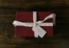 How to Make My Ex Miss Me Desperately: 5 Ancient African Rituals That Work in 24 Hours Red gift box with white ribbon and handwritten tag on rustic wooden background. - how to make my ex miss me desperately