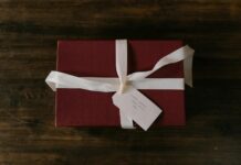 How to Make My Ex Miss Me Desperately: 5 Ancient African Rituals That Work in 24 Hours Red gift box with white ribbon and handwritten tag on rustic wooden background. - how to make my ex miss me desperately