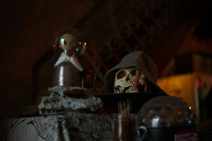 Eerie still life with a skull and decor for a spooky Halloween atmosphere. - signs a voodoo spell is working on my ex